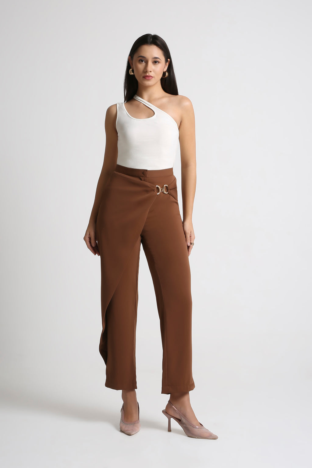 Woman wearing a white top and brown pants on a white background